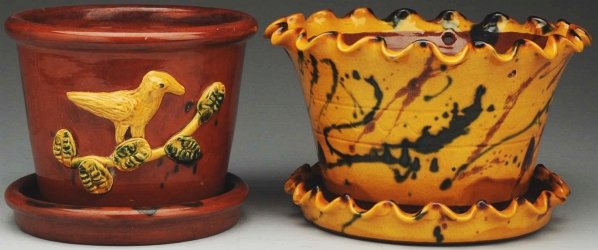 Pair of Redware Lester Breininger Flower Pots.: Largest: 5 - 3/4" T. Includes one yellow slip-decorated with ruffled edges and one with applied bird on branch decoration. Both appear to be in original condition. (Good).