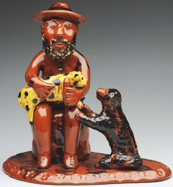 Unusual Lester Breininger Figural.: 8" T. Depicts a bearded man holding a dog. Piece is attached to an incised base. One firing line in base is a manufacturing imperfection. (Near Mint).