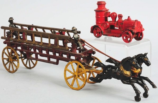 Cast Iron Toys & Marbles.: Includes one cast iron horse-drawn hook and ladder fire truck, one small fire truck, and a grouping of machine and hand-made marbles. Condition (Excellent). Size 15" L.