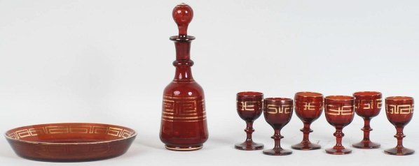 Bohemian Cranberry Blown Glass Pieces.: Circa 1880. Includes a decanter, six cordials, and one under plate. All pieces are hand-blown. Condition (Excellent). Size 8 - 1/2" T.
