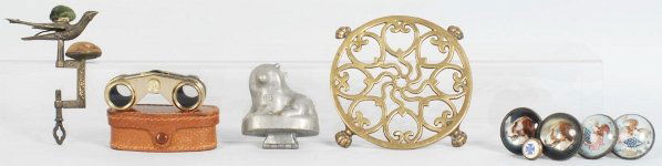 Lot of Miscellaneous Items.: Includes an 1853 sewing bird, lion ice cream mold, two pairs of curtain holders (eagles and dogs), one brass trivet, and one pair of binoculars in case. Condition (Excellent).