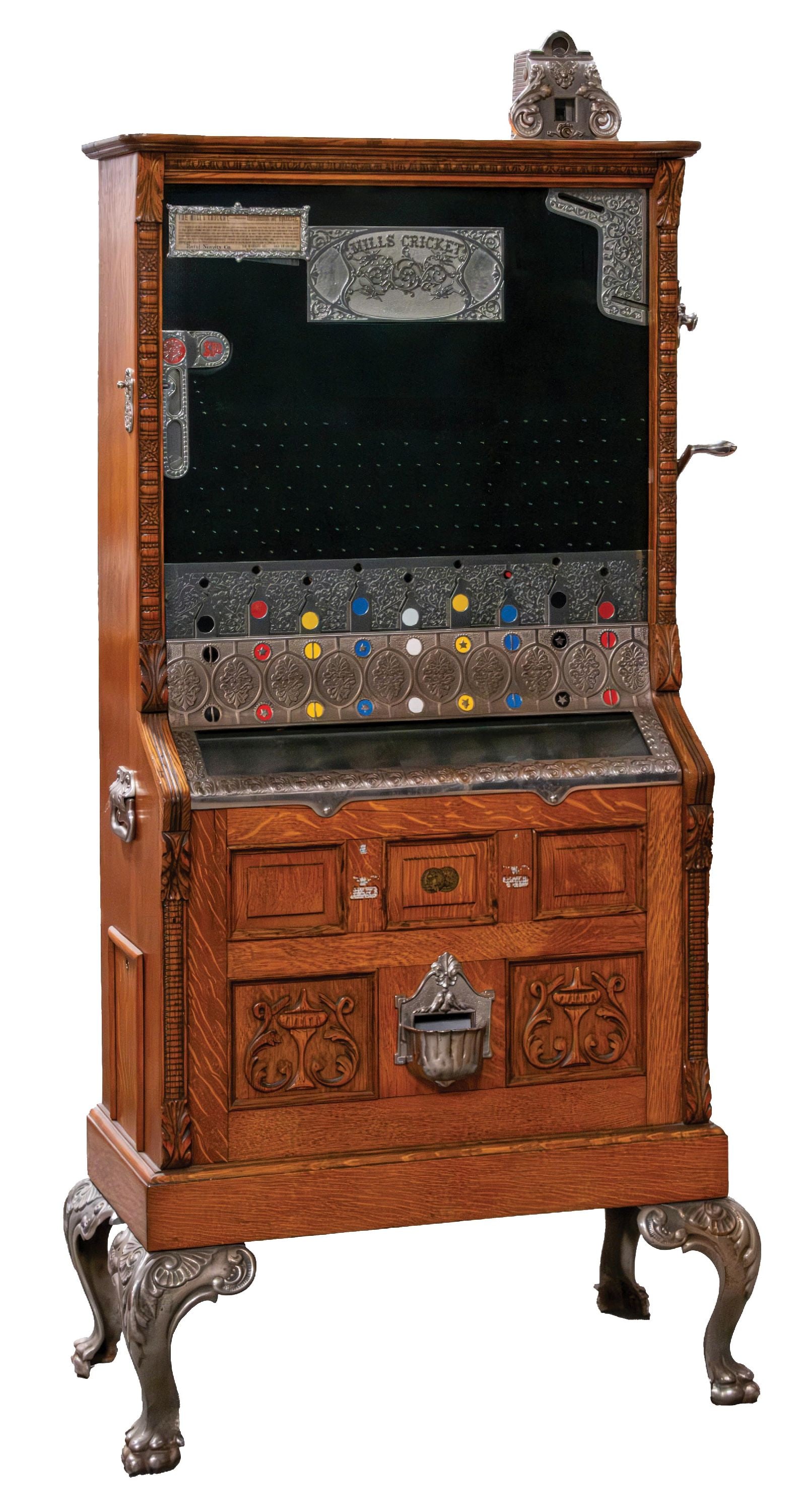 5¢ MILLS CRICKET FLOOR MODEL COIN FLIP SLOT MACHINE: C. 1905. The Mills Novelty Co. CONDITION: Beautifully restored with a fantastic surface patina on this quartered oak cabinet with egg and dart moldings, recessed panels and impressive ornately detaile