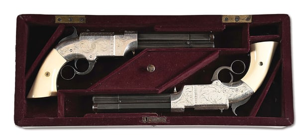 (A) HANDSOME CASED PAIR OF ENGRAVED VOLCANIC REPEATING ARMS NO. 2 NAVY MODEL LEVER ACTION PISTOLS.