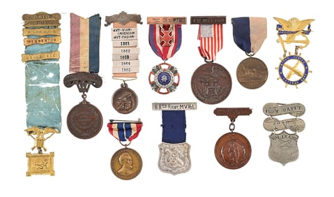 LOT OF 11: US CIVIL WAR GAR AND VETERAN BADGES.