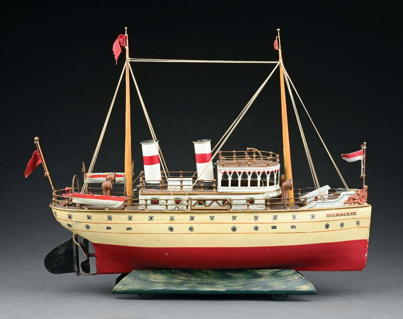 MARKLIN CAT. REF. 5044 "MILWAUKEE" BOAT W/ CLOCKWORK POWER: C. 1909. CONDITION: One side railing gate and front cloth flag are replaced. Retains original parts, including the stand and key. Excellent to near mint overall. Item Dimensions: 20" x 4" x 16 - 1/2".