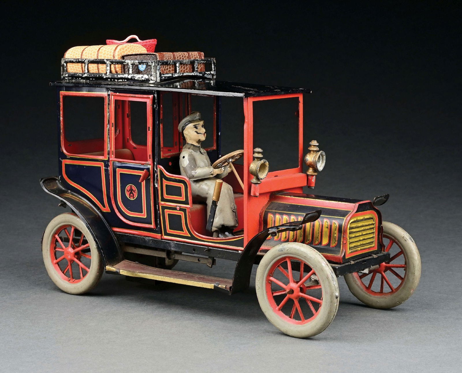 HANS EBERL TIN LITHO CLOCKWORK LIMOUSINE W/ HAND-PAINTED DRIVER: CONDITION: Includes three more contemporary pieces of luggage. Some paint flaking to luggage rack; otherwise, excellent condition, could clean to a better grade. Item Dimensions: 11" x 5" x 7 - 1/2".