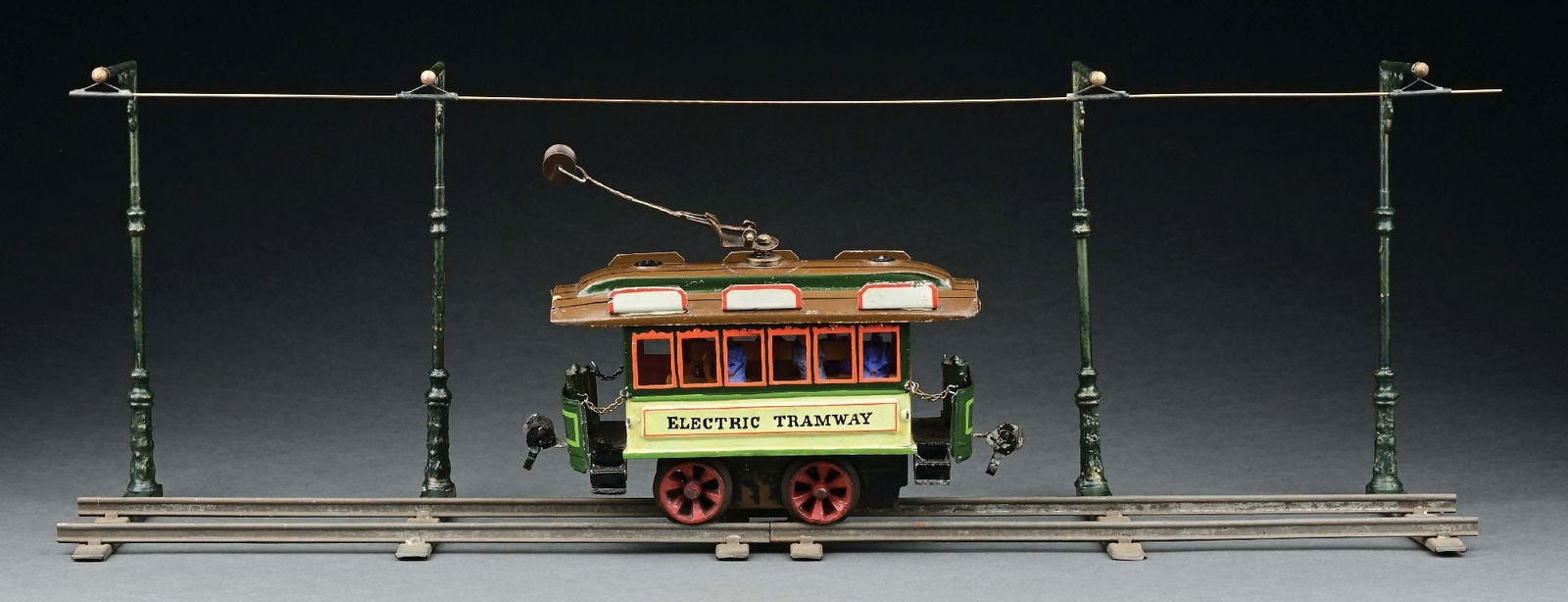RARE MARKLIN CLOCKWORK TRAMWAY IN GREEN: C. 1900. Includes six original figures, four original cantenary poles. CONDITION: Near mint. ILLUSTRATED: Pressland, David. Pressland's Great Book of Tin Toys. New Cavendish Books, 1995, pp 281, fig.