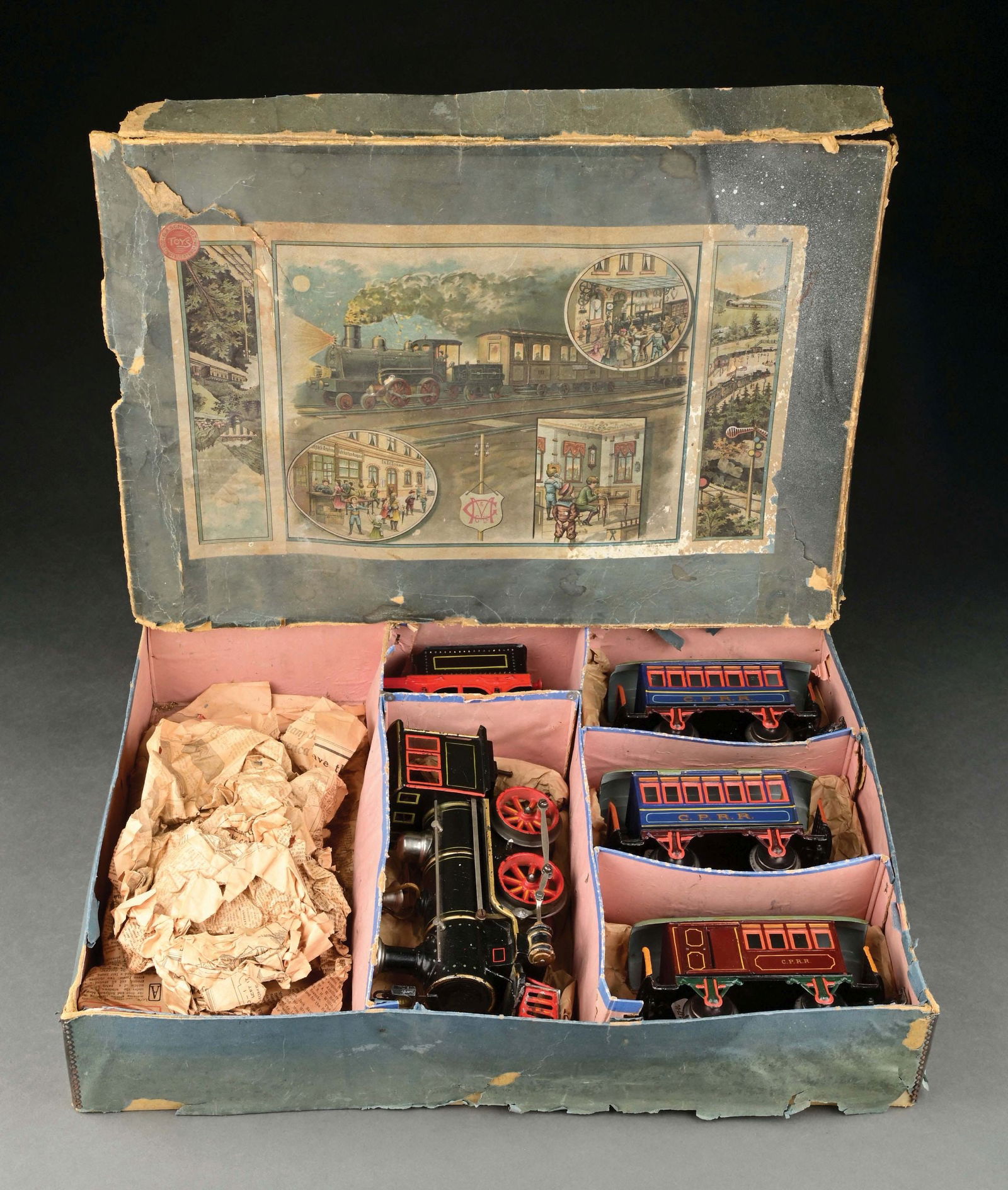 MARKLIN I GA. AMERICAN MARKET SET IN ORIGINAL BOX: C. 1904-1905. Consisting of: 0-4-0 Locomotive with original headlight, Combine Car and two Coaches with C. P. R R. Set box has sticker from FAO Schwartz in New York. Original wrapping and newspaper wr