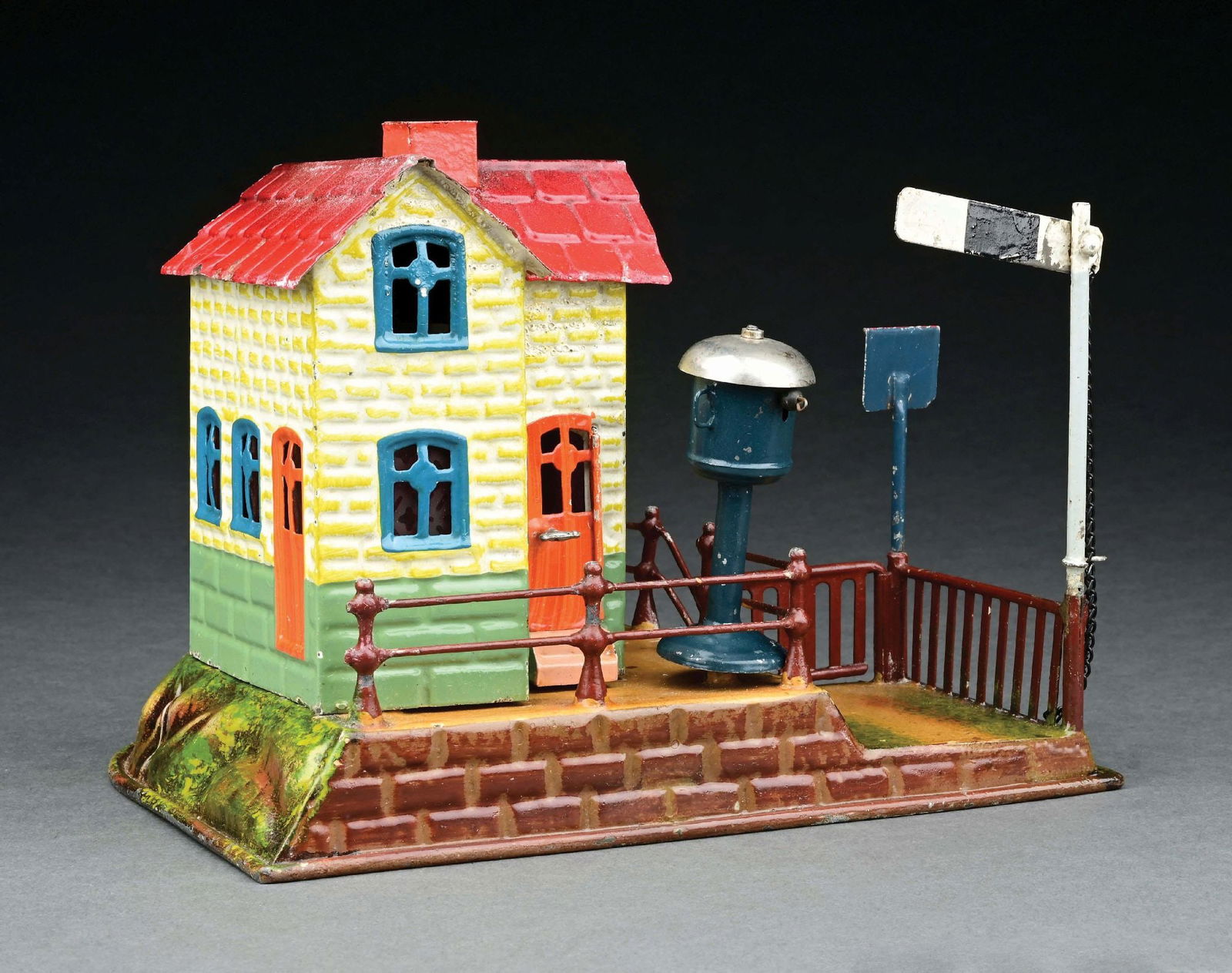MARKLIN HAND PAINTED RAILWAY CROSSING GUARD HOUSE: c. 1904-1909. Original sign, bell and semaphore. CONDITION: Sodder repair to semaphore fence post. Otherwise near mint. Item Dimensions: 8" x 6 - 1/2" x 6".