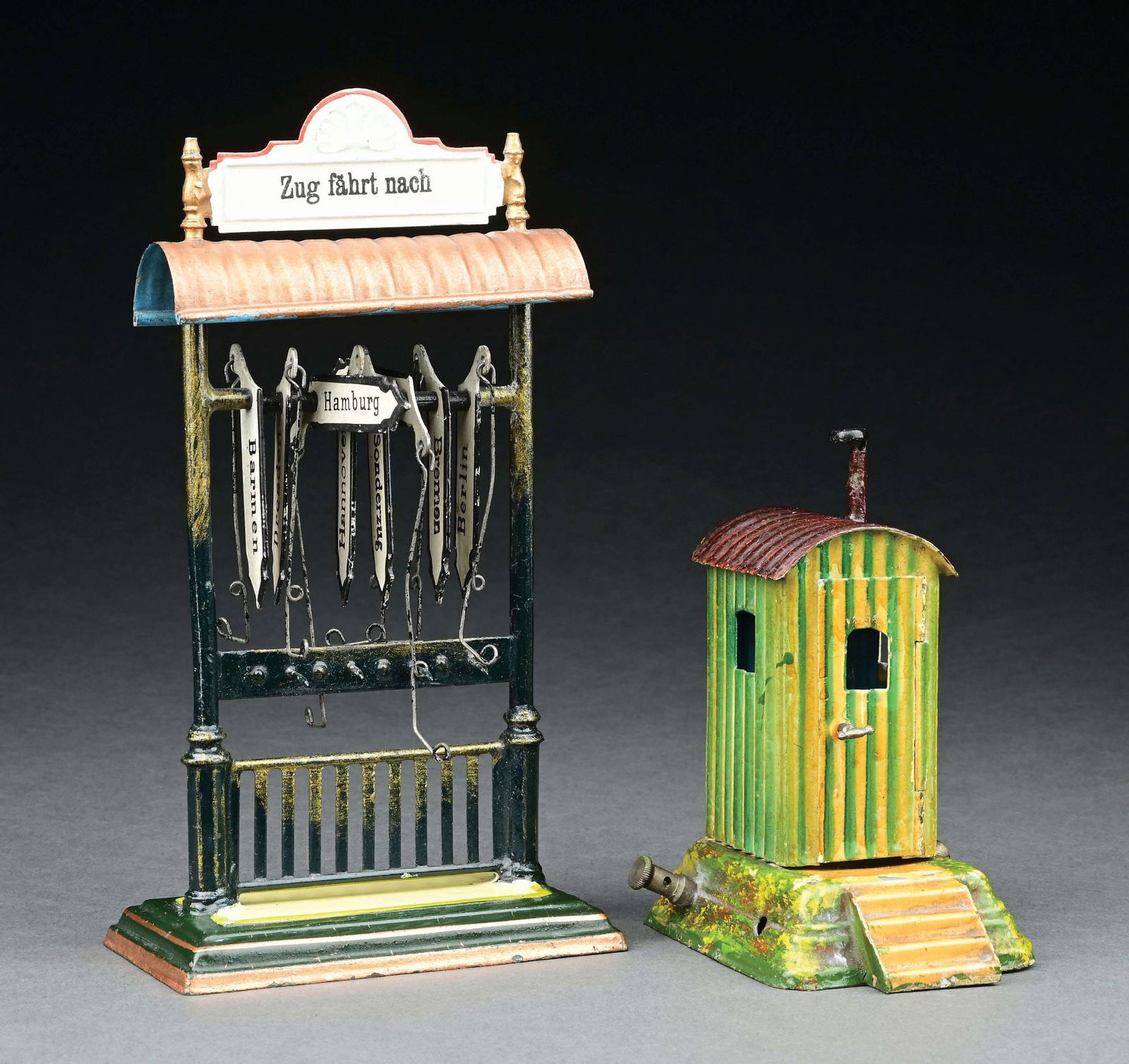 LOT OF 2: MARKLIN HAND-PAINTED DESTINATION BOARD & ELECTIC LIT GUARDHOUSE: CONDITION: Guardhouse is missing two terminal pickups and is in excellent condition. Destination board has German city inscriptions and is near mint. Item Dimensions: Largest: 4 - 1/2" x 2 - 1/2" x 8