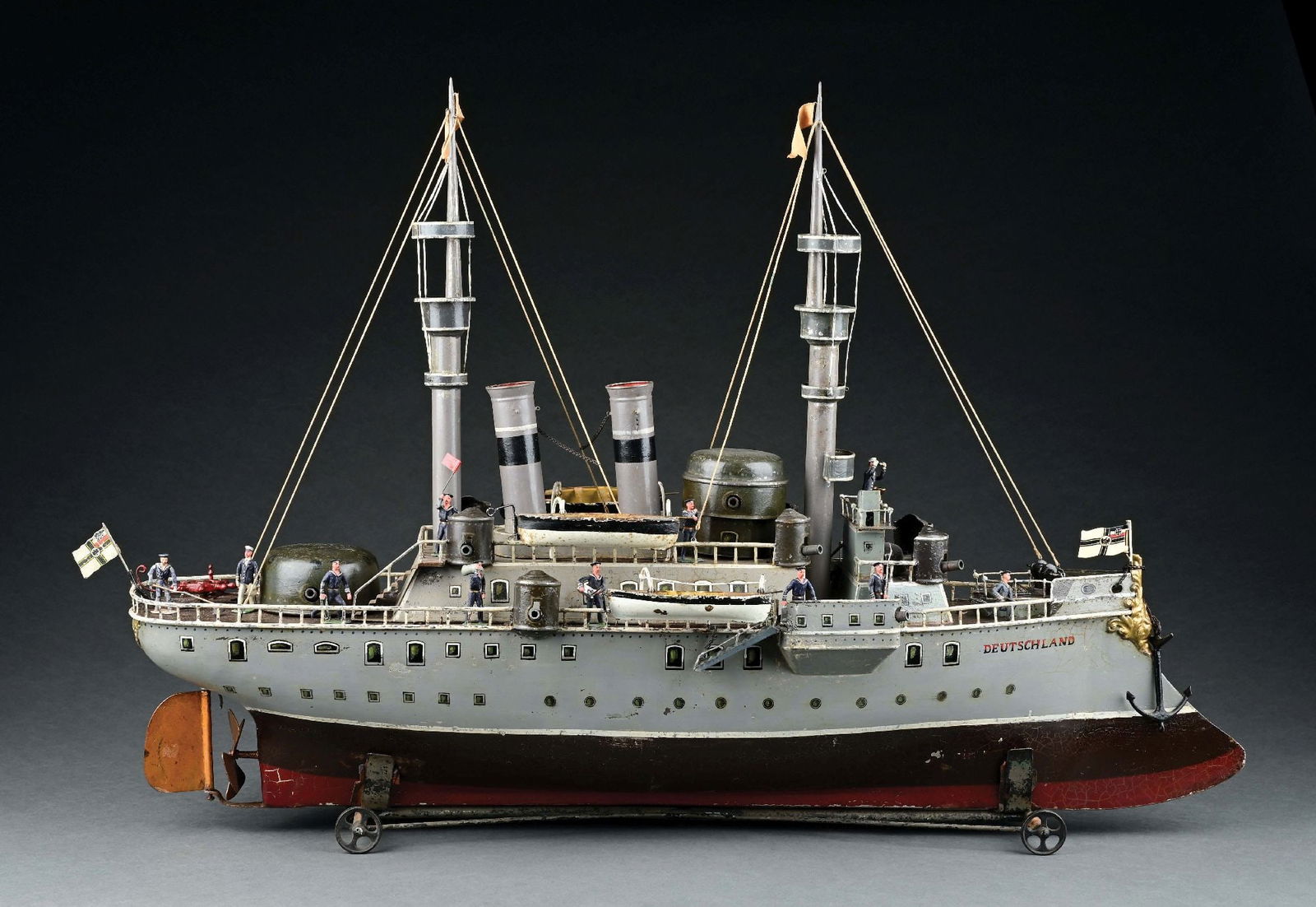 MARKLIN CAT. REF. 10094 "DEUTSCHLAND" W/ CLOCKWORK POWER: A boat with an extremely impressive presence. Includes some original Heyde figures. CONDITION: Some below-deck windows have some re-touch, but otherwise an excellent original boat with four original l