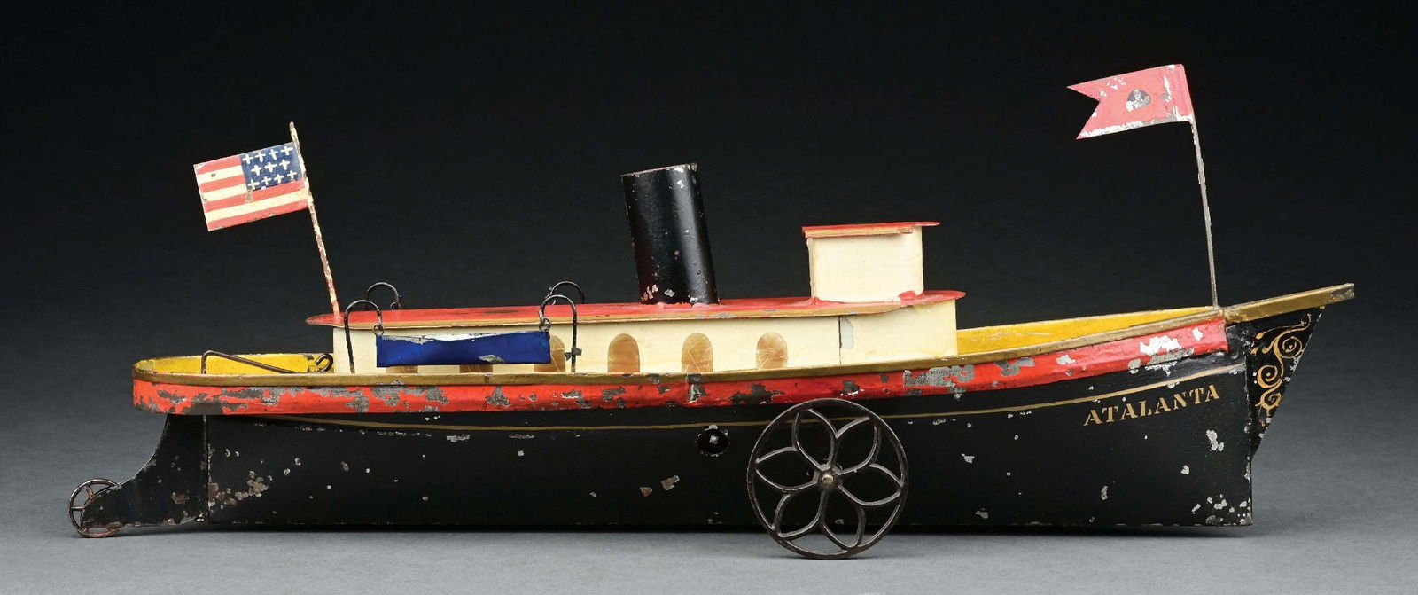 IVES AMERICAN TIN ATALANTA YACHT: Very few examples known, but this is probably the best known example. It is clockwork, and has nice bright paint coloring. It looks all original, except the front flag that is reattached. It has been