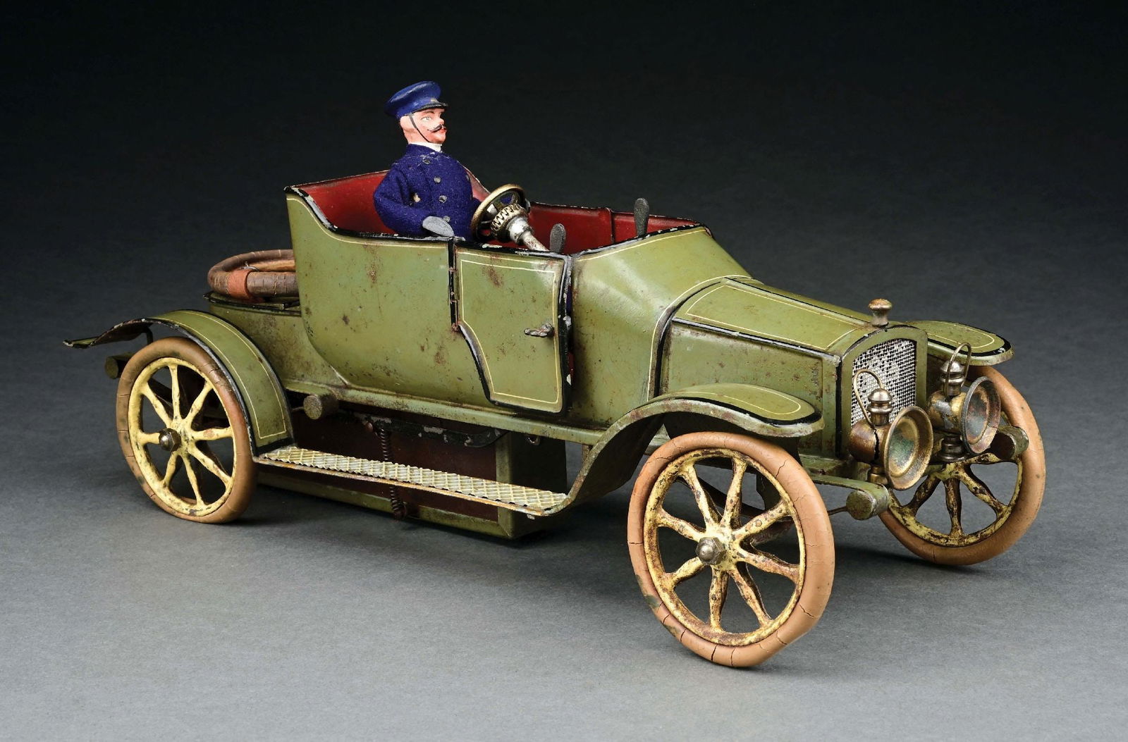 MARKLIN HAND-PAINTED OPEN 2-SEAT CLOCKWORK-POWERED CAR: C. 1915. CONDITION: Retains original tires. Superb replacement driver. Original headlamps and spare tire. Excellent condition overall. Item Dimensions: 14" x 6" x 5".