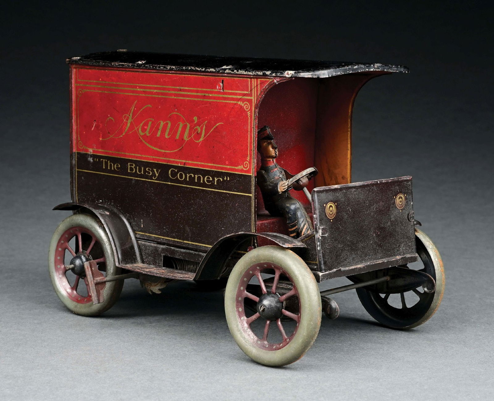 HANS EBERL TIN LITHO WIND-UP KAMN'S "THE BUSY CORNER" TRUCK: It has the original backdoors and driver. There is slight crazing to the roof. CONDITION: Excellent Condition. Item Dimensions: 8" x 4 - 1/2" x 5 - 1/4".