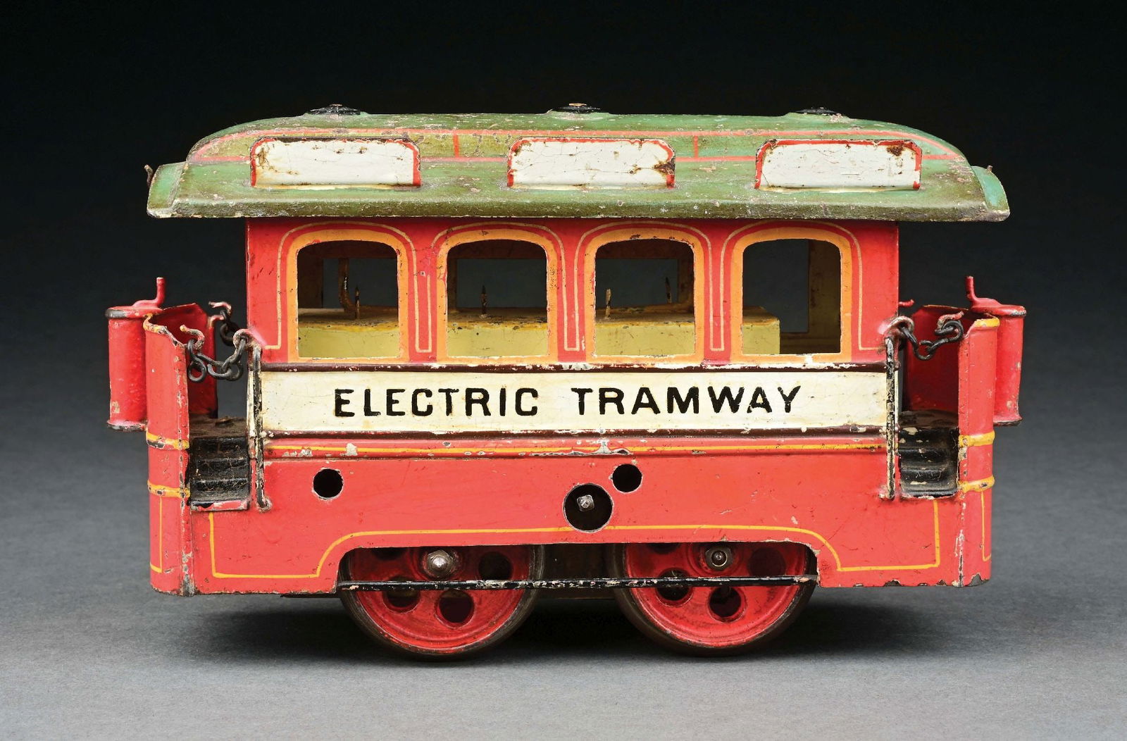 MARKLIN CLOCKWORK 4-WINDOW TRAMWAY IN RED: C. 1905. CONDITION: The roof is in very good condition, the body is in excellent condition. Missing couplers. Item Dimensions: 8 - 3/4" x 3" x 5".