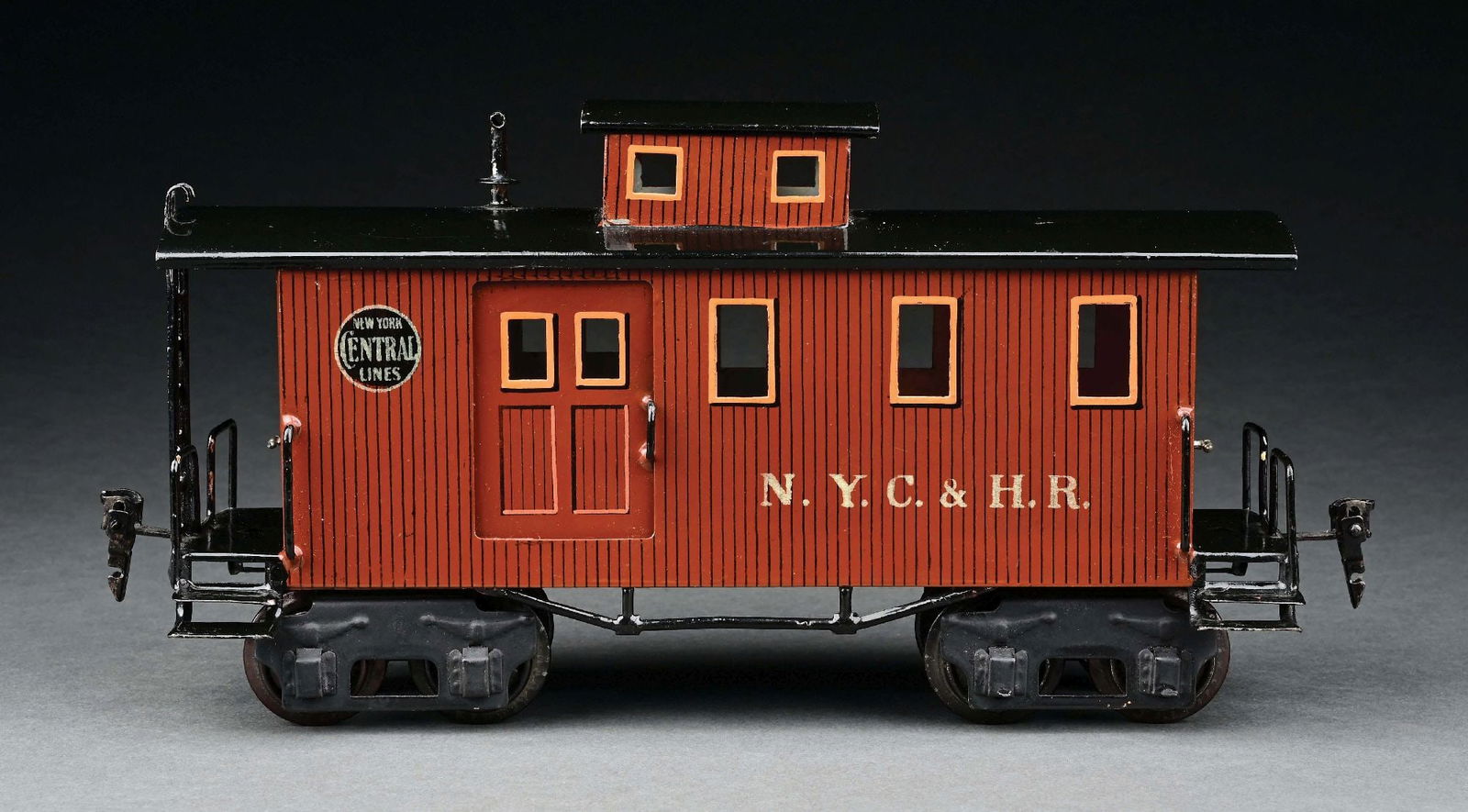MARKLIN I GA. PAINTED CABOOSE: C. 1910-1914. N. Y. C. & H. R. lettering. CONDITION: Near mint. Item Dimensions: 11 - 3/4" x 3 - 1/4" x 6".