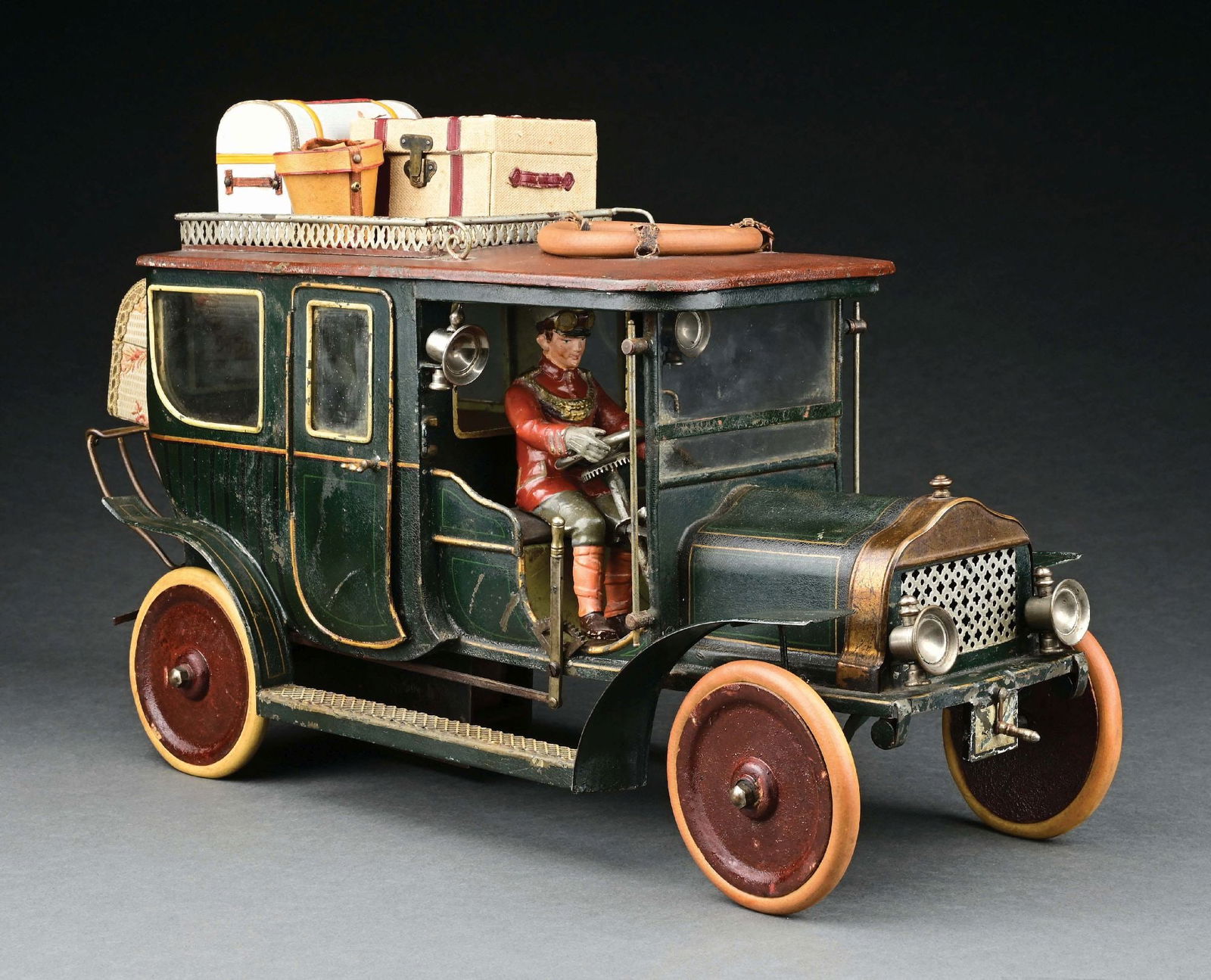 MARKLIN CAT. REF. 5214/3 HAND-PAINTED CLOCKWORK-POWERED LIMOUSINE IN GREEN: C. 1912-1914. According to the ILLUSTRATED: Pressland, David. Pressland's Great Book of Tin Toys. New Cavendish Books, 1995, solid disc wheels indicate these were replaced for the American market by M