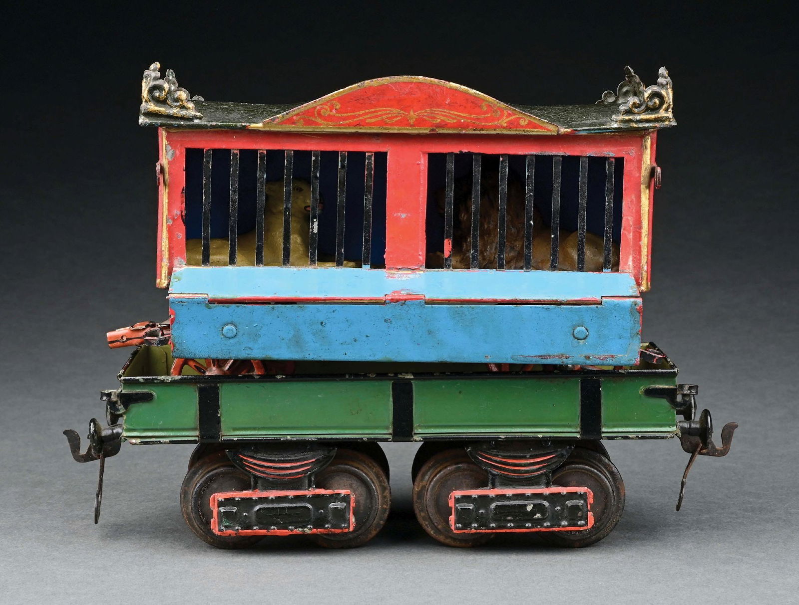 MARKLIN I GA. HAND-PAINTED HAGENBECK'S MENAGERIE CAR: Two-compartment version with rare matching orange yoke. Includes two Lineol figures. CONDITION: Excellent. Item Dimensions: Largest: 7" x 3" x 4 - 1/2".