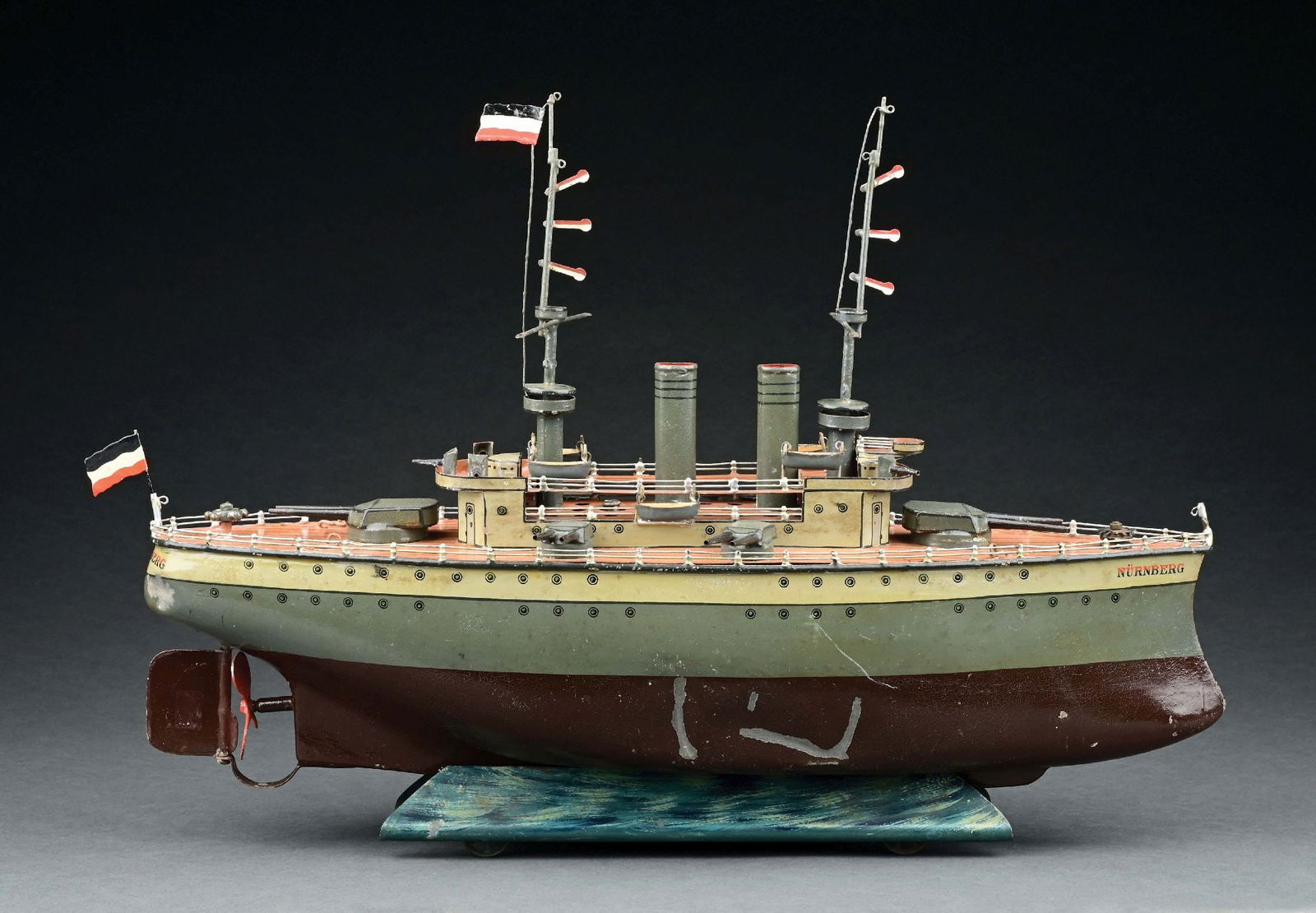 MARKLIN CAT. REF. 5129 "NURNBERG" 3RD SERIES BATTLESHIP W/ LIVE STEAM PROPULSION: C. 1915-1921. CONDITION: Retains original parts including, oiler and funnels for filling steam plant. Replaced rear flag. Overall condition is excellent to near mint, with exception of two indentation
