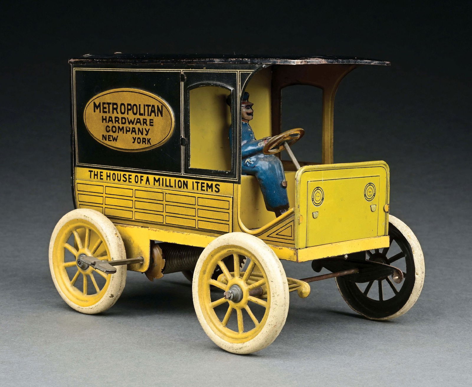 HANS EBERL TIN LITHO WIND-UP METROPOLITAN HARDWARE TRUCK: Made from 1910 to 1920 in Germany. It has the original driver and backdoors. There is minor to moderate scratching and wear. CONDITION: Excellent Condition. Item Dimensions: 7 - 1/2" x 4 - 3/4" x 6".