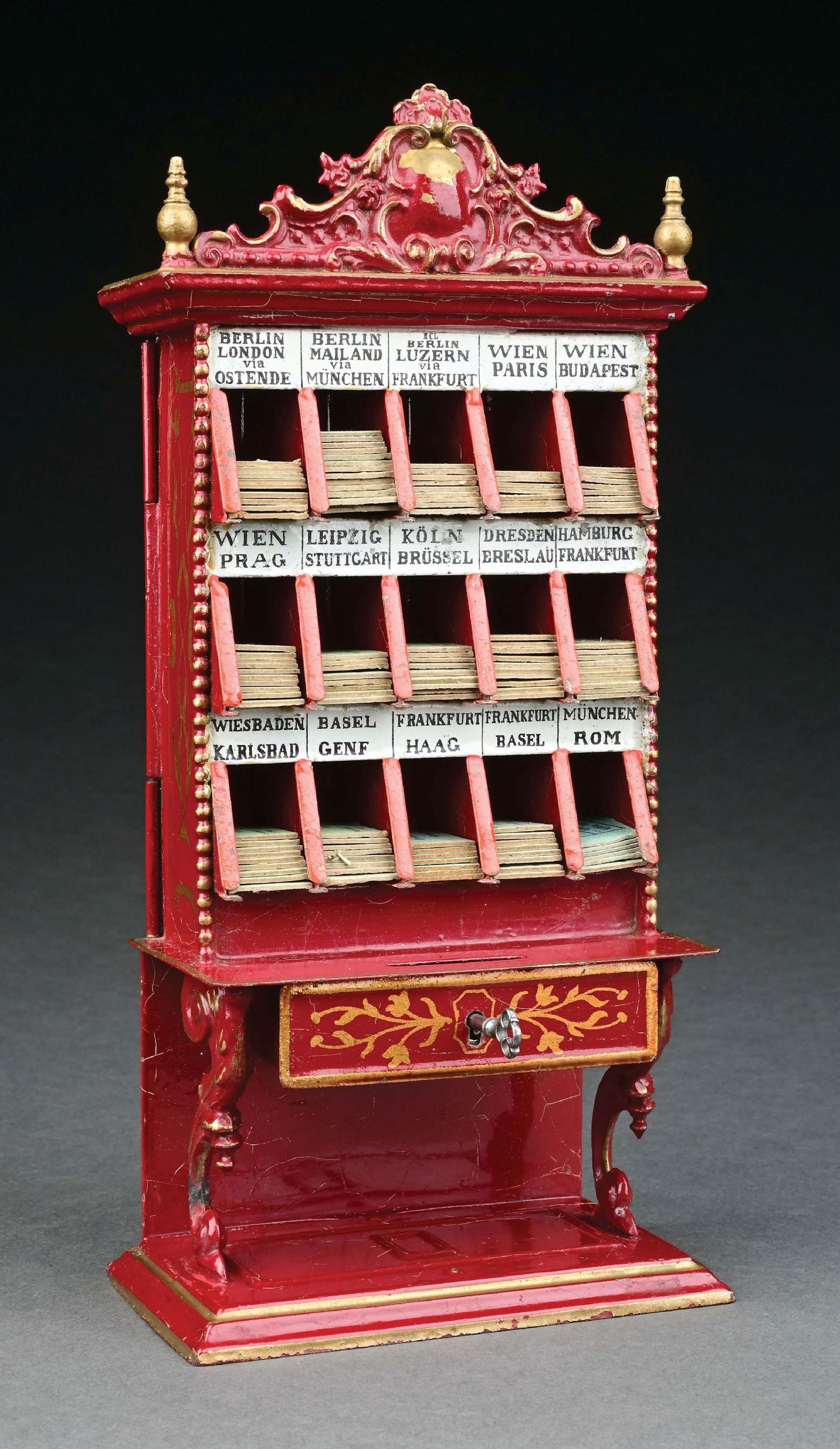 MARKLIN CAT. REF. 2093 HAND-PAINTED TICKET DISPENSER IN RED: C. 1904-1909. CONDITION: Includes many original tickets and key. On the back side there is a tag for the OCH Fréres store in Genéve. Near mint overall. Item Dimensions: 5" X 3" X 10 - 3/4".