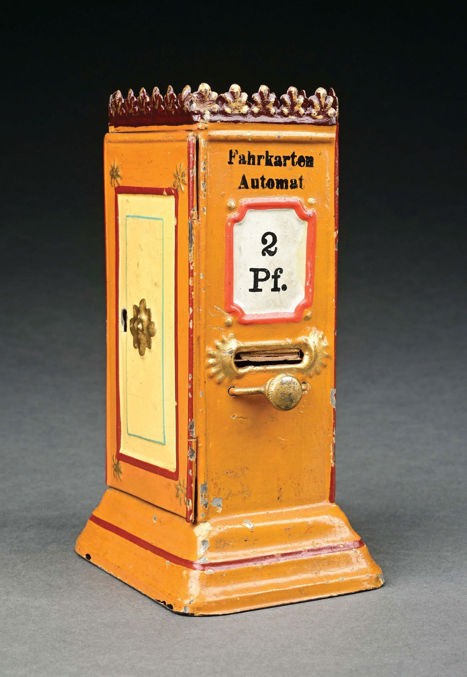 MARKLIN CAT. REF. 2092 HAND-PAINTED TICKET DISPENSER W/ COIN SLOT IN YELLOW: C. 1904-1908. CONDITION: Lacking key; otherwise, near mint condition. Item Dimensions: 3 - 1/2" x 2 - 3/4" x 5 - 7/8".