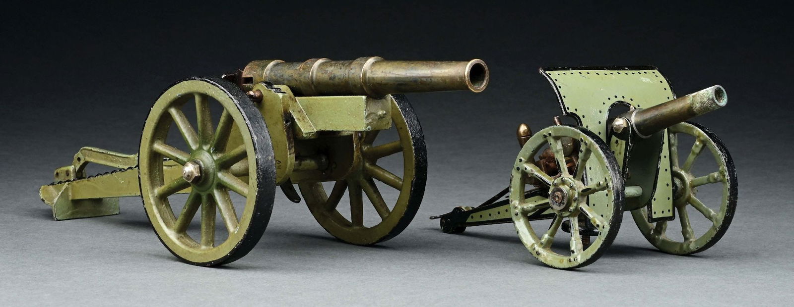 LOT OF 2: MARKLIN TIN AND CAST IRON CANNONS: CONDITION: Near mint. Item Dimensions: Largest: 13 - 1/2" x 4" x 3 - 1/2".
