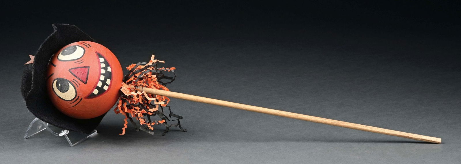 HALLOWEEN PUMPKIN TOY RATTLE: Charming papier mache ball-shaped head, painted and decorated to appear to be a come-alive pumpkin at Halloween. Glued to the back of the head is a felt black hat with wide brim and a cutout star appl