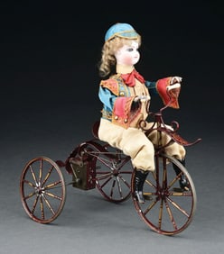 INCREDIBLE ALL ORIGINAL TOY WITH BOY CYCLIST POSITIONED ON A TRICYCLE