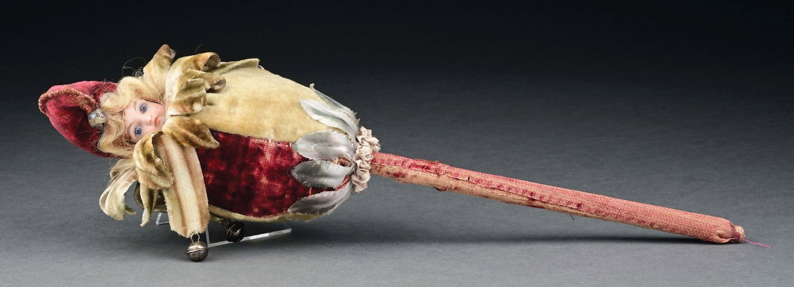 MUSICAL MAROTTE DOLL/TOY: Musical Marotte doll/toy dressed in harlequin-type hat with bells on a stick. When one holds the cloth-covered stick at the bottom and twirls around, it spins in a circle, the bells start to sound, an