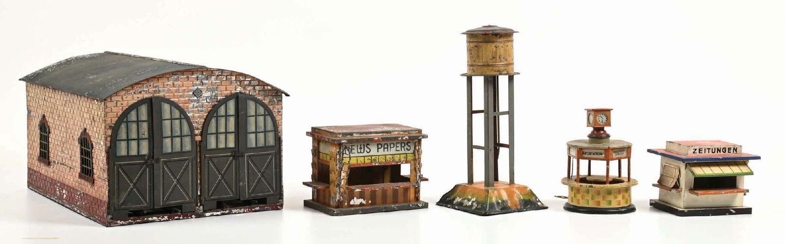 LOT OF 5: EUROPEAN STRUCTURES BY KIBRE, BING & MARKLIN: (A) A newspaper stand made by Kibre for the U.S. Market. It has some significant paint loss, good condition. (B) A complete and all original Bing newspaper stand with newspapers. There scratches and p