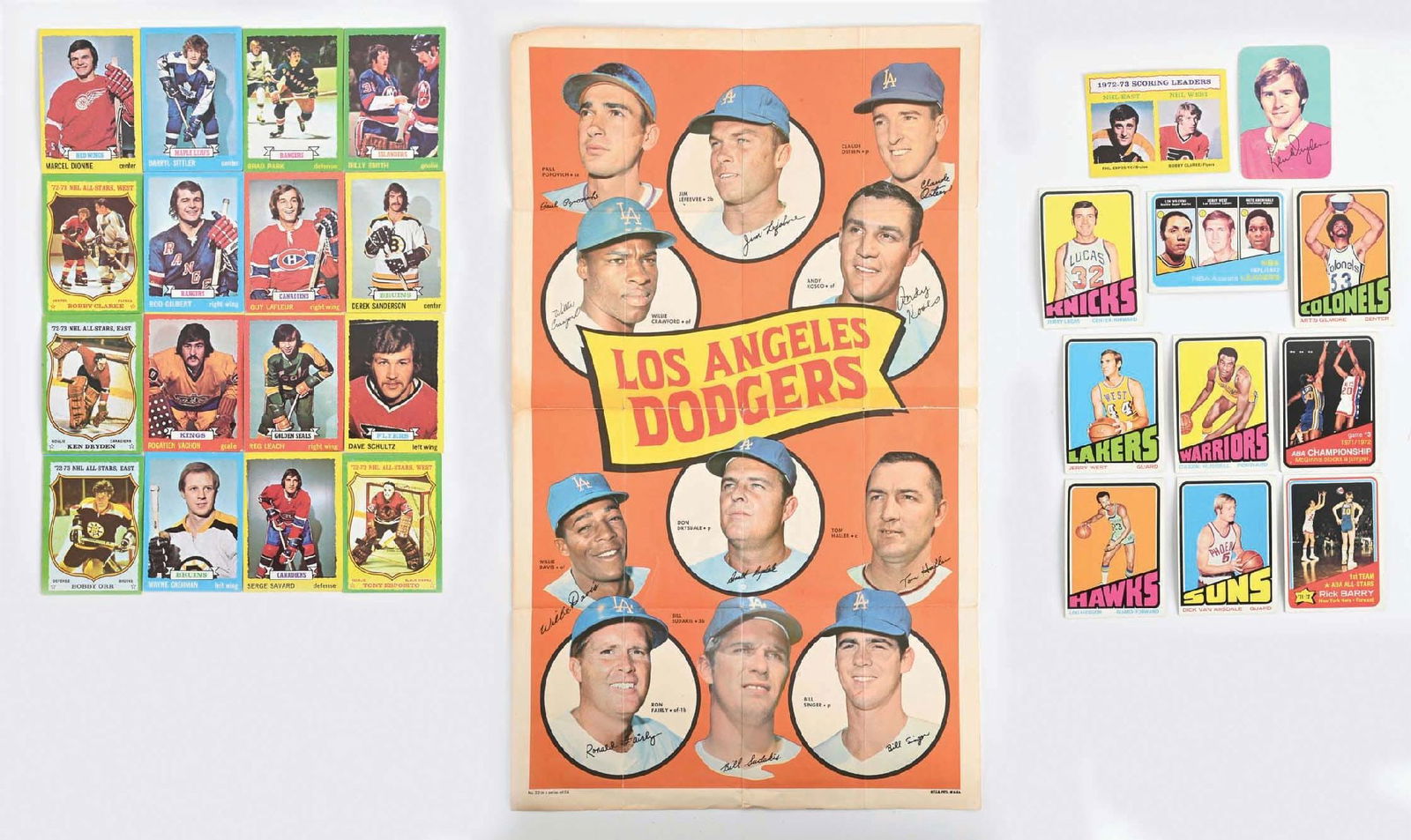 LARGE LOT OF APPROXIMATELY 250 VINTAGE 1970S TOPPS HOCKEY & BASKETBALL CARDS: Includes approximately 40 basketball cards, including cards from the NBA and ABA, including ABA stars Rick Barry and Artis Gilmore. The Gilmore card looks to be a rookie card. The NBA cards feature Je