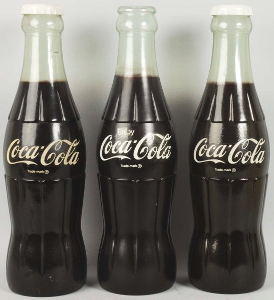 Lot of 3: Coca-Cola Plastic Display Bottles.: 1970s to 1980s. Two have caps with them. All have period applied factory details. Just little wear. Condition (Excellent - Near Mint). Size Each: 24" T.