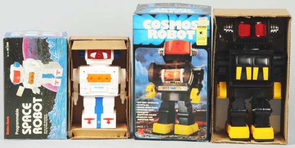 Lot of 2: Battery-Operated Space Robot Toys.: Plastic. Both are marked "Made in Hong Kong". Includes one Radio Shack programmable Space Robot and one Camco Cosmos Robot. Old store stock. Includes both original boxes with some slight wear overall.