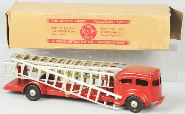 Pressed Steel Fire Ladder Truck Toy.: Canadian. Made by Windsor Metals Limited. Toy has minor scratching and two small spots of wear on cab roof and right rear fender. Includes original box with some flaps detached but present and some cr