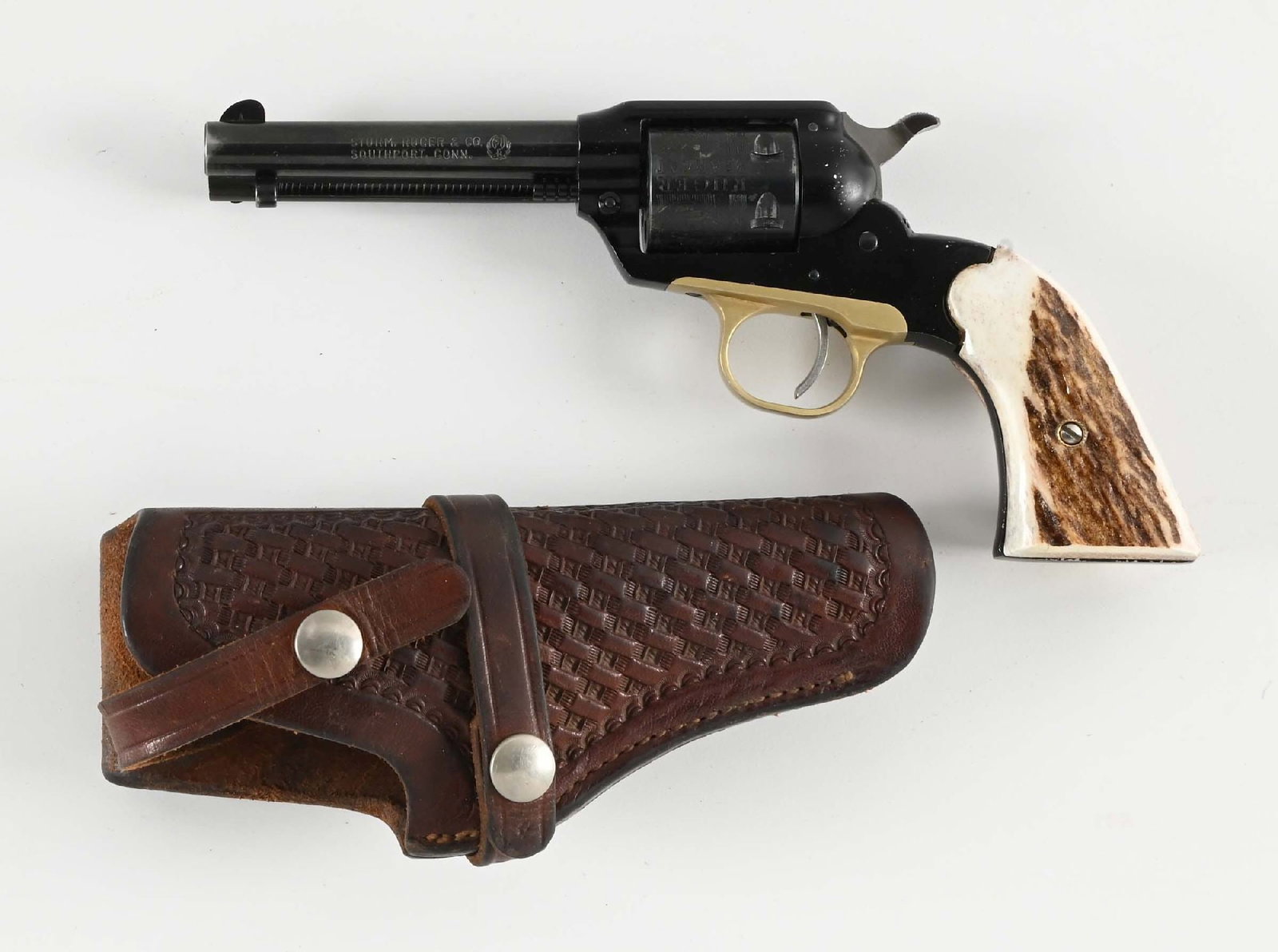 (C) RUGER BEARCAT SINGLE ACTION REVOLVER.: Manufactured in 1967. Features a two tone blue finish, roll die cylinder, stag grips, and red insert on front sight. CONDITION: Excellent. There is some wear on loading gate. light muzzle wear and a f