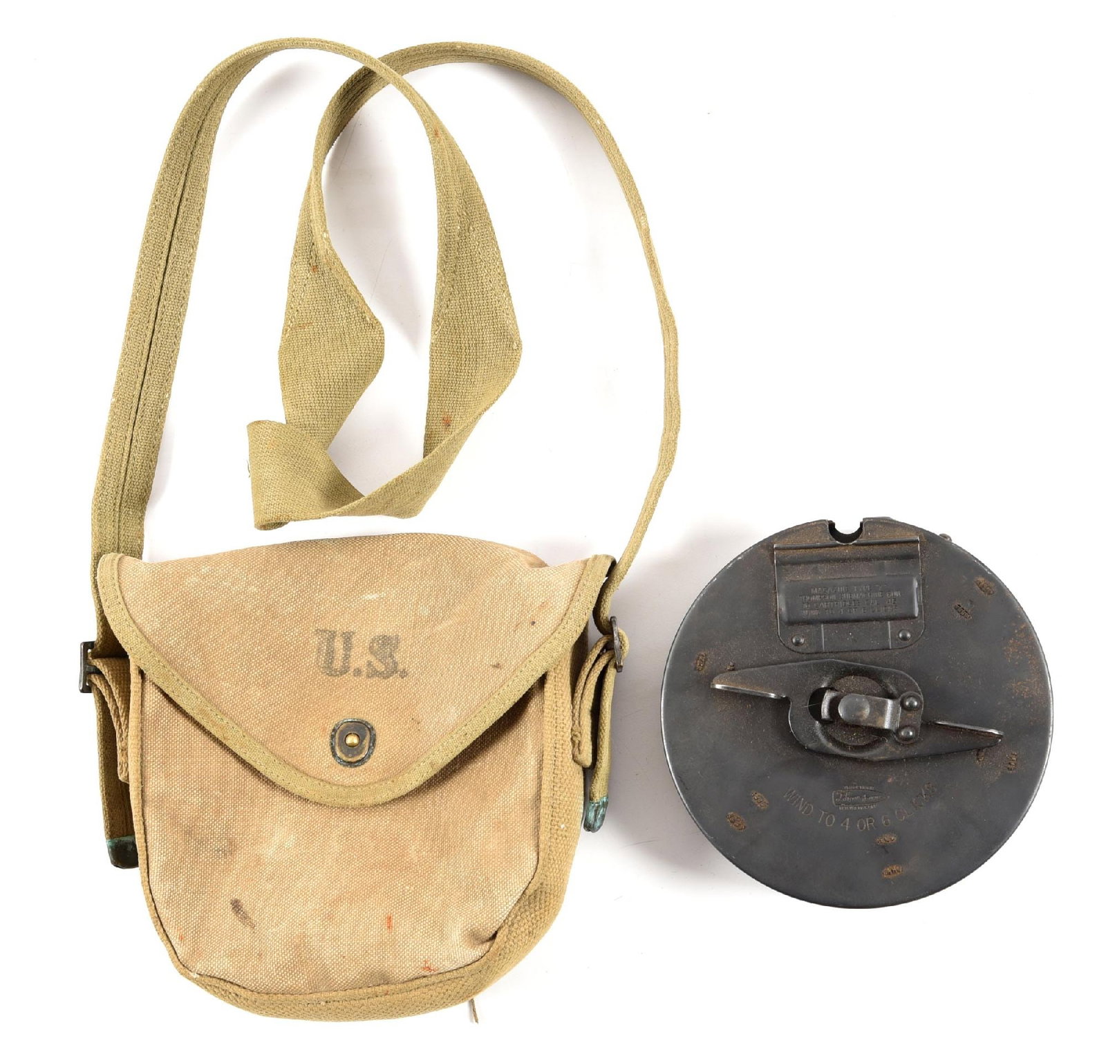 AUTO ORDNANCE X TYPE 10 ROUND THOMPSON DRUM WITH CARRIER AND TOOL.: Manufactured with a 10 round capacity but still the actual size and shape of a Thompson 50 round drum. Complete with 1942 dated US marked canvas carrier, manual, and drum installation device. CONDITIO