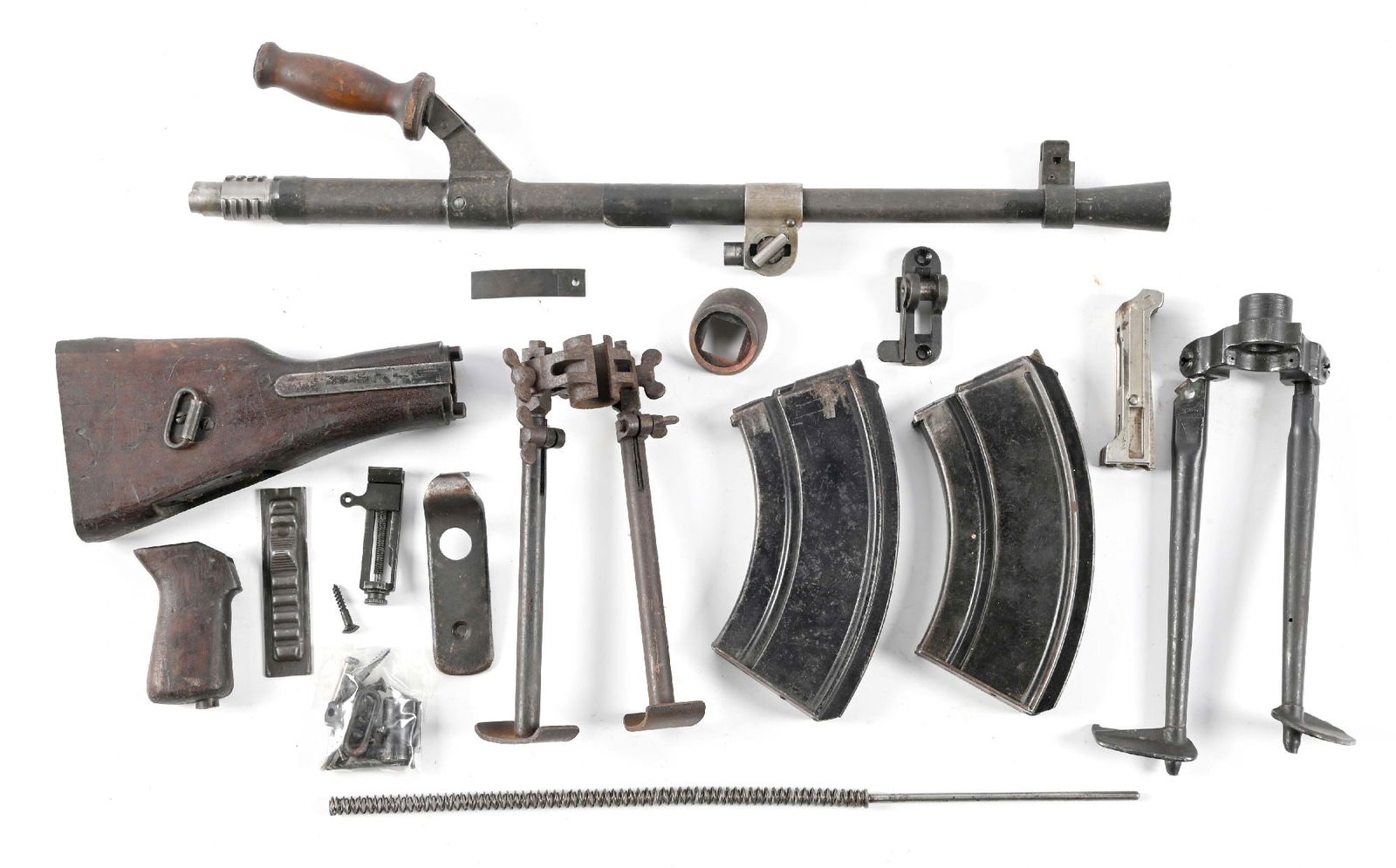 LOT OF BREN PARTS INCLUDING BARREL.: Lot consists of 2 magazines, 2 bipods with brackets, 1 barrel, stock and pistol grip, and various small receiver parts. CONDITION: Demilled spare parts.