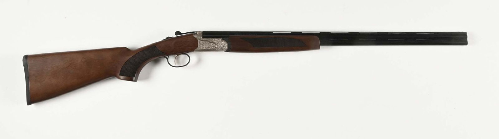 (M) MOSSBERG SILVER RESERVE II OVER UNDER .410 SHOTGUN.: Blue barrels with a full-length vent rib. Satin nickel receiver with light engraving on both sides. Checkered hardwood stock with pistol grip, solid black pad, and matching forearm. Gold trigger. COND
