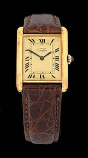 CARTIER TANK WRISTWATCH WITH BOX: Cartier "les must de Cartier" tank watch in gold vermeil over sterling silver. Roman Ivory dial, 22mm case with mechanical wind Swiss movement. Replacement strap with original tang/buckle installed. I