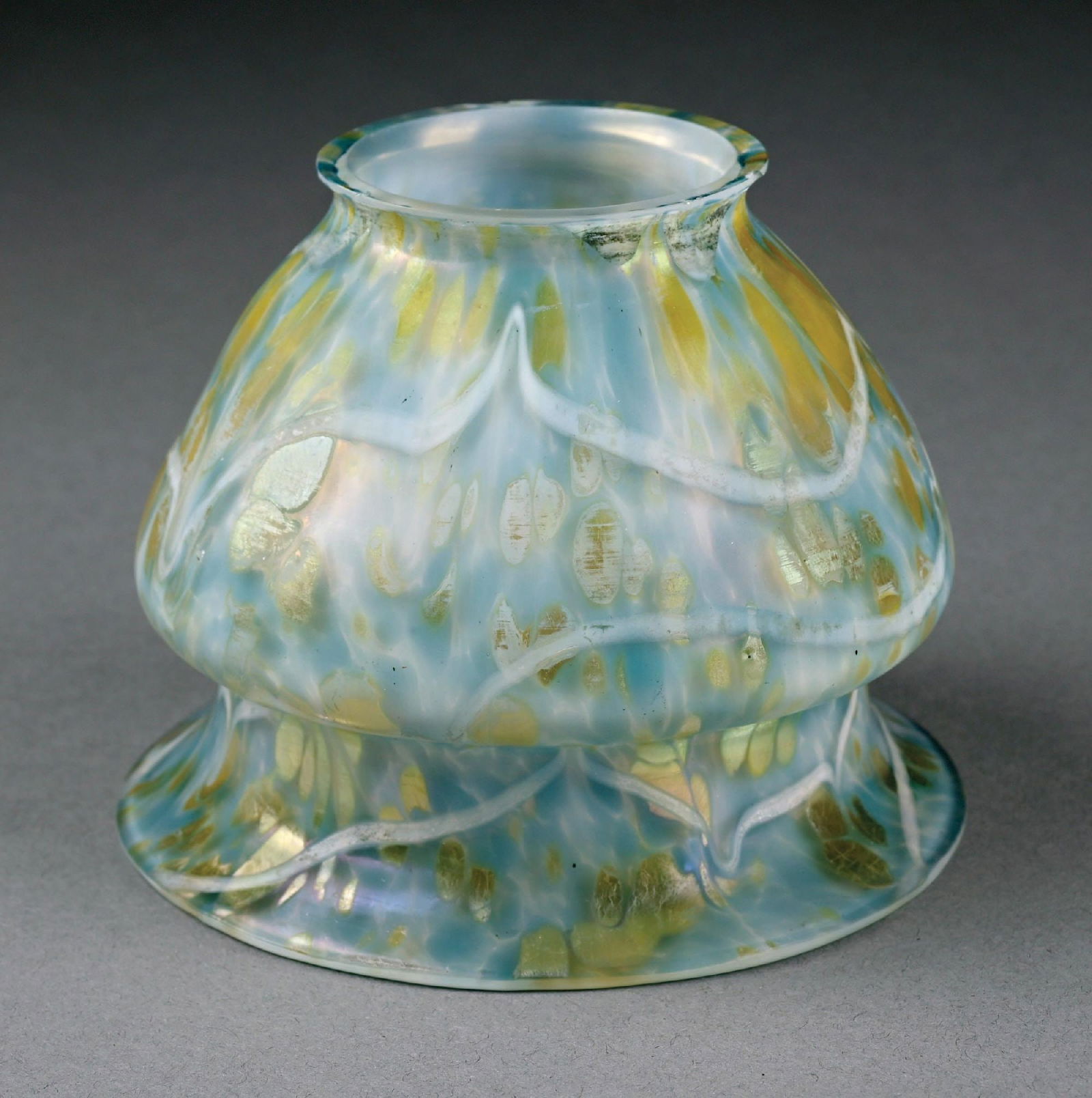 BLUE OPAL LOETZ GLASS SHADE: C. 1901, PN II-2/677. A beautiful glass shade by Loetz. The 3-1/2" tall shade has a diameter of 4-1/2" at the mouth. The shade is composed of lovely blue mottled glass with iridescent oil spot design.