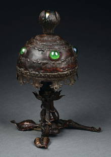 AUSTRIAN PATINATED METAL AND JEWELED LAMP: A beautiful Austrian Art Nouveau table lamp. The round, patinated metal shade is decorated with a series of green jewels and is finished in a red-brown patina and with stylized cloud motif. It sits on