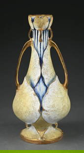 AMPHORA 2-HANDLED VASE W/ EXTRUDED FLOWERS & LEAVES AT BASE & TOP: C. 1902. Enameled and matte glazes and applied gold gilt. Amphora oval, Austria oval, original paper label, impressed "3946" and "42." Literature Scott, Richard. Ceramics from the House of Amphora Sid
