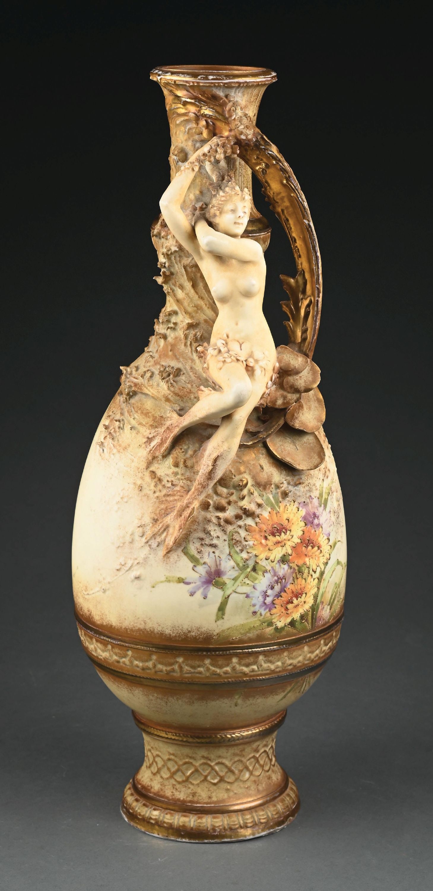TALL EARLY AMPHORA MERMAID VASE, C. 1890: A finely decorated example, ivory porcelain, multicolored polychromed flowers on a raised stylized base with an applied mermaid and floral handle. RSTK mark, impressed 104, D, Made in Austria. Similar