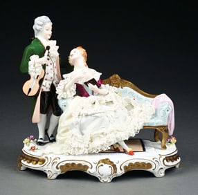 DRESDEN STANDING GENTLEMAN & LADY SEATED ON LOVESEAT FIGURINE