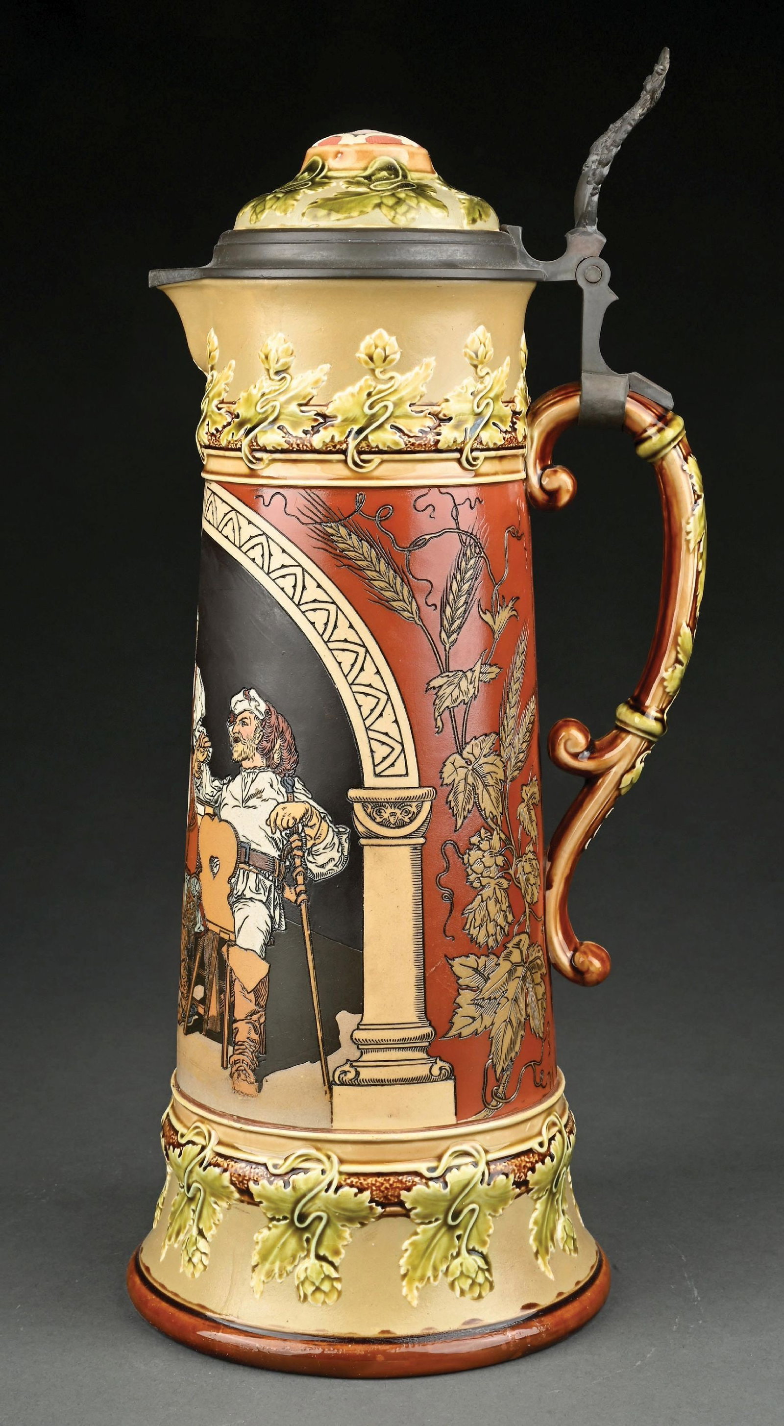 METTLACH EMBOSSED STEIN #2692: Barmaid with mandolin player. Etched 3L. with inlay lid. Small imperfection show on the floor in the graphic. Does not traverse to the interior, most likely occurred during production. Condition: (Exc