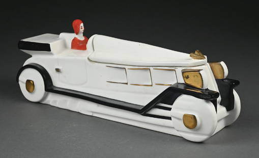 VINTAGE ROBJ PORCELAIN ART DECO AUTOMOBILE TOBACCO POT: Rare Lidded porcelain automobile tobacco pot with driver. Marked, "ROBJ Paris, made in France." Black and white car with painted gold accents and driver wearing red. Condition: (Excellent). Dimensions