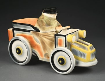 MAN DRIVING AN AUTO LIDDED CERAMIC ADVERTISING FIGURINE