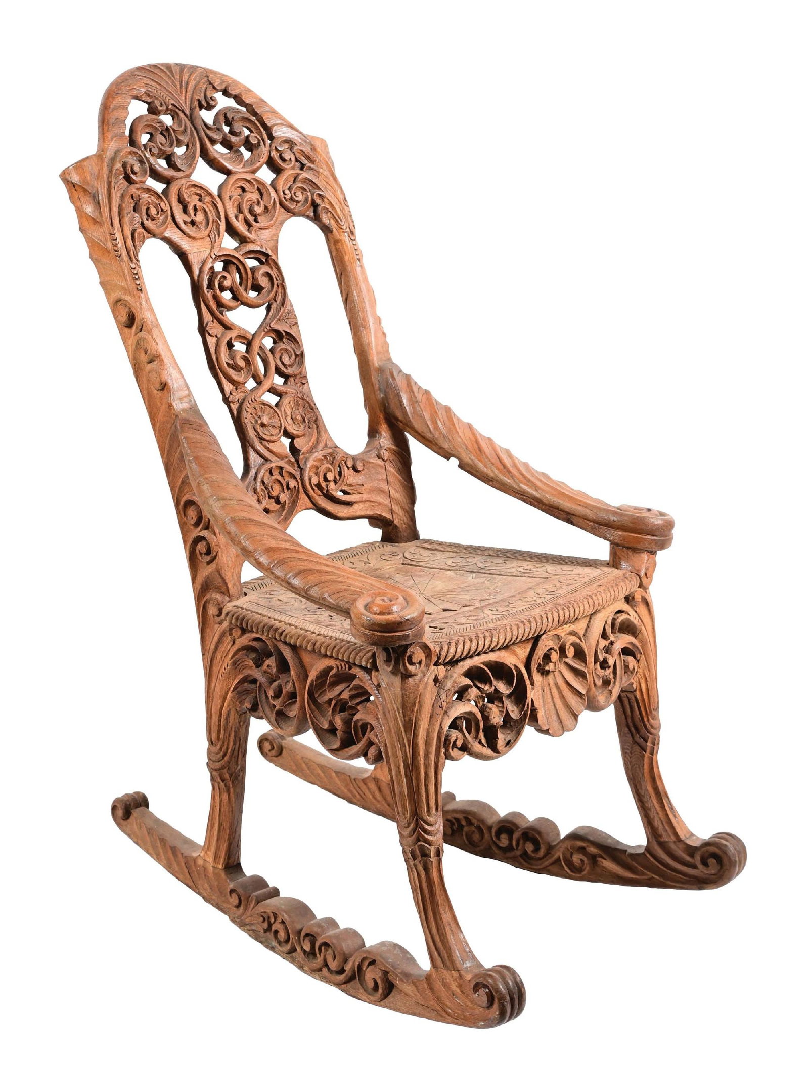 ORNATELY CARVED WOOD FLORAL & SCALLOPED ROCKING CHAIR: C. 1910. Ornately carved wood rocking chair. Good condition. This is not a standard shippable item and will require 3rd party shipping or pickup arrangements to be made. Condition: (Good). Dimensions: