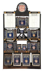 SOCONY PETROLEUM PRODUCTS SERVICE STATION OIL CAN DISPLAY CABINET COMPLETE W/ CANS: C. 1920s. A rare piece of Socony service station advertising complete with fifteen one gallon motor oil cans, four five gallon motor oil cans and seven individual grease cans. CONDITION: Display shelf